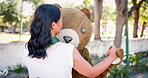 Costume, business and woman dance outdoors with teddy bear for promotion or entertainment with company mascot. Female person, funny or ridiculous outfit for comedy or humor, quirky and hilarious.