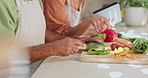 Cooking, hands and couple in kitchen with healthy food for salad, nutrition and cutting ingredients for lunch. Diet, vegetables and man helping woman at counter with knife, recipe and dinner at home