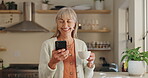 Senior woman, phone and typing with tea in home, reading notification and scroll on blog. Elderly female person, typing and text for communication, coffee and social media for funny joke or laugh