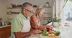 Cooking, help and mature couple in kitchen with healthy food for salad, nutrition and cutting ingredients for lunch. Diet, vegetables and man with happy woman, knife and recipe and dinner at home