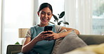 Happy, smartphone and asian woman laughing on sofa for social media, internet meme or text message. Smile, mobile phone and young female person for chatting, networking or relax on couch in apartment