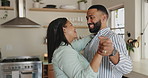 Couple, dancing and happy in home kitchen with care, bonding and holding hands for connection. Man, woman and moving together with love, smile and steps with rhythm, memory and fun in apartment
