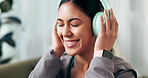 Music, headphones and sofa for happy woman, listening and radio or song streaming. Technology, podcast and audio or electronics in living room, happy and smile for relax Asian female person on couch