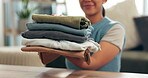 Laundry, clean clothing and holding pile of washing, smile and finished household chores. Hands, linen or fabric for spring clean in home, housewife or housekeeper for sanitary hygiene or organising