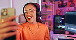 Video call, gamer and happy woman with headphones in neon home for social media post with lights by computer. Live streaming, esports and person on phone, influencer and girl talking for online blog