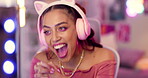 Neon, headphones and woman by computer for live streaming, social media and vlog for creative career at home in bedroom. Gen z girl, influencer and happy content creator with technology for podcast