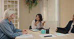 Business people, women and meeting in boardroom with team, discussion and conversation at media startup. Group, employees or staff in negotiation, planning and documents for review in modern office