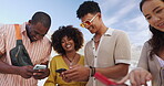 Phone, happy and friends on beach in summer together for communication, holiday or vacation. Smile, social media or laughing with group of young people at ocean or sea for app browsing and sharing