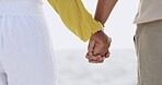 Beach, love and closeup of couple with holding hands for unity, romance and support on vacation. Ocean, people and adventure with connection for commitment, care and holiday together on island