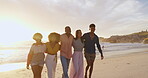 Friendship, group and sunset on beach for bonding, together and happy with hug in nature. Summer, ocean or laugh for walk on vacation or holiday seaside in Los Angeles, connection and support at dusk