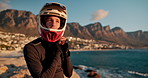 Man, biker and beach with helmet for sunset cruise, road trip or journey by scenic view in nature. Face of male person or cyclist with headgear or protection for travel or adventure by ocean coast