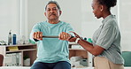 Resistance band, physiotherapy and senior man in clinic for consultation with muscle recovery. Injury, healthcare and woman physical therapist help elderly male patient with stretching arm exercise.