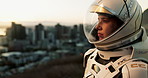 Space, travel and astronaut in city with view, future dystopia and planet discovery in suit. Earth, aerospace mission and person in helmet on urban adventure for research, science and sci fi universe