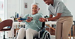Weight, physiotherapy and senior woman in wheelchair at consultation for recovery. Injury, healthcare and physical therapist helping elderly female patient with arm exercise in rehabilitation clinic.