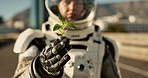 Space, planet and hands of astronaut with plant for nature, environment and ecosystem restoration. Science fiction, fantasy and spaceman for exploration, adventure and journey on abandoned world