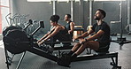 Rower, gym and people with exercise, training and intense workout with rowing and endurance progress. Group, health center and men with woman and support with fitness, power or cardio with wellness