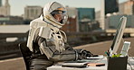 Astronaut, city and typing with computer on road for communication, email or networking in an urban town. Space traveler, person or worker chatting or browsing for connection on desk PC in the street