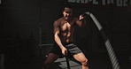 Man, exercise and battle ropes for gym challenge with strong determination, workout or building muscle. Male person, speed and fitness wellness for training or fast performance, equipment or athlete