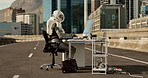 Astronaut, city and road with computer for communication, email or networking in an urban town. Space traveler, person or worker chatting, typing or browsing for connection on desk PC in the street