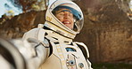 Astronaut, video call and explore planet on nature mountain for expedition journey on earth, environment or technology. Person, spacesuit and connection in forest for discovery, travel or sunshine