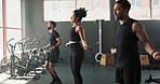 Fitness, skipping rope and group of athletes in gym for health, wellness and body workout. Team, jumping and people and personal trainer with equipment for cardio exercise at class in sports center. 