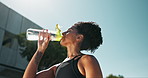 Fitness, wellness and woman and drinking water for hydration, workout and training for health outside. Tired runner, cardio exercise and drinking liquid for resting, break and active in summer
