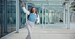 Business, good news and happy woman by a building dancing to celebrate success, winning bonus or deal. Outdoor, job promotion or excited employee on sidewalk with target, smile or goal achievement