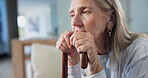 Senior, woman and sad in retirement with cane, depression and thinking of disability with loneliness. Female person and walking stick in nursing home for arthritis, nostalgia and thoughts of memories