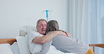 Senior couple, support and hug in hospital for love, care and kindness with sick husband. Comfort, man and woman embrace in clinic for empathy, talk and healthcare visit for cancer rehabilitation