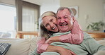 Smile, face and senior couple hugging on sofa in living room at home relaxing and bonding with love. Happy, care and portrait of elderly woman embracing husband in retirement in lounge at house.