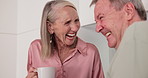 Senior, couple and talking with coffee or laughing in kitchen for gossip story, retirement and conversation in home. Elderly people, hot beverage and happiness with joke, wellness and morning break