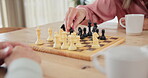 Senior couple, chess and hand on board for strategy, knowledge and happy competition. Thinking, planning and smart elderly woman with game for learning, problem solving and challenge in retirement