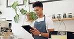 Man, cafe and barista with order on tablet at counter for sale, ecommerce and service at shop. Male person, small business and waiter with technology for website, networking or online menu update