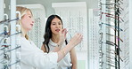 Store, customer and consultation with optometrist for glasses and helping woman with advice or choice. Prescription, spectacles and person shop with decision for eyewear and lens with frame in retail
