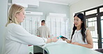 Store, woman and customer with glasses, payment and salesperson, helping and smile. Eyewear, shop and female people, vision and advice for sale, frame and healthcare, buying and happy for purchase
