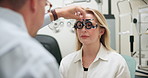 Ophthalmologist, woman and test frame for eye care, healthcare or wellness in consultation for vision. Medical exam, optometry and patient on lens for check up or trial with hand of doctor in clinic