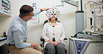 Ophthalmologist, woman and eye exam for vision, healthcare or wellness in consultation. Medical test, optometry and patient on phoropter machine for eyesight or check on lens with doctor in clinic