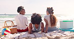 Beach, picnic and back of girl friends on summer vacation, adventure or holiday together. Blanket, basket and group of women relaxing on sand watching ocean or sea on tropical weekend trip by island.