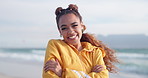 Woman, face and smile at beach on holiday, breeze and travel to Jamaica for winter vacation. Black female person, portrait and wind by ocean waves for peace, happy and weekend trip to tropical island