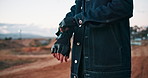 Riding, gloves and biker outdoor with protection for driving motorcycle with safety in countryside. Person, hands and cyclist closeup with leather gear for travel on motorbike for road trip journey