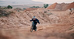 Man, bike and off road for race, action or adventure on sand at cycling rally in Dubai. Electric bicycle, professional rider and person on dirt for extreme sports, fast and speed for jump outdoor