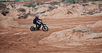 Man, bike and off road for sports, action or adventure on sand at cycling rally in desert. Electric bicycle, professional rider or person on dirt for extreme race, fast or speed for challenge outdoor
