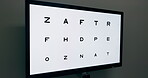 Optometrist, test and vision of letters in eye exam with screen on wall for assessment in office, Reading, text and screening for eyesight with technology or monitor in optometry with no people