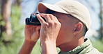 Binoculars, man and wildlife watching in nature with travel and eco adventure of college student with hobby. Forest, journey and vacation with view in Mexico on a woods and walking trail for wellness