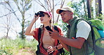 Couple, binoculars and hiking with phone in nature to explore for outdoor expedition together in the woods. Hiker or tourist sightseeing in forest with scope or smartphone for adventure or discovery