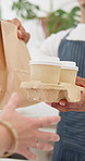 Waiter, hands and coffee with bag for customer service, buying or purchase at indoor cafe. Closeup of employee serving caffeine drink or beverage with package for sale, order or payment at restaurant