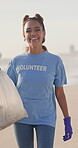 Woman, face and volunteer with plastic bag with pollution on beach as community activist, trash or responsibility. Female person, smile and ngo clean up for waste management, recycling or cleaning