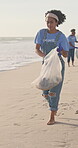 Women, volunteer and teamwork on beach for cleaning as community service, pollution or plastic. Female people, trash bag and activist group for climate change recycling or rubbish, environment or sea