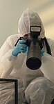 Person, home and forensic photographer for evidence at crime of burglary, investigation or examination. Hazmat suit, camera and pictures in living room for homicide case research, accident or csi