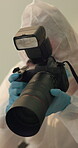 Forensic, photographer and crime scene picture for evidence in home, investigation or hazmat suit. Person, gloves and camera observation for research inspection or burglary theft, proof or analysis